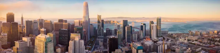 Panoramic view of San Francisco skyline featuring modern skyscrapers, including Salesforce Tower, with the Bay and distant hills in the background, relevant to digital marketing and technology discussions.